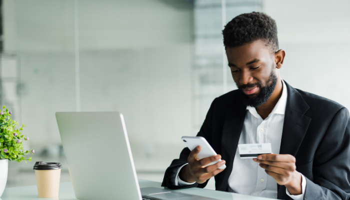 man looking at debit card